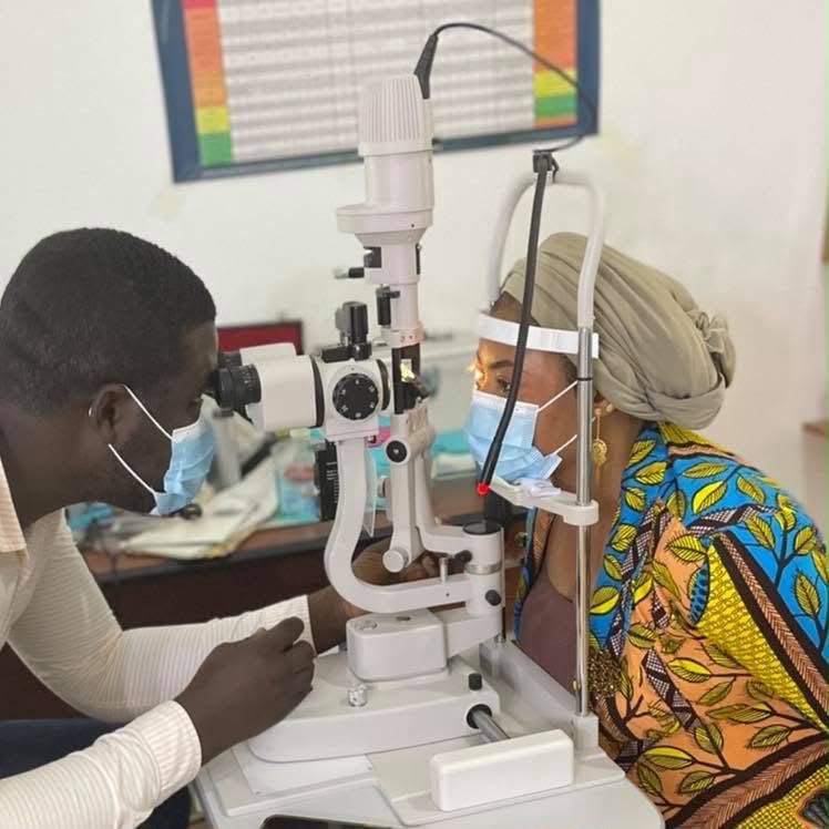 An optometrist at Premier Vision Eye Care examining a patient's eyes at the slit lamp
